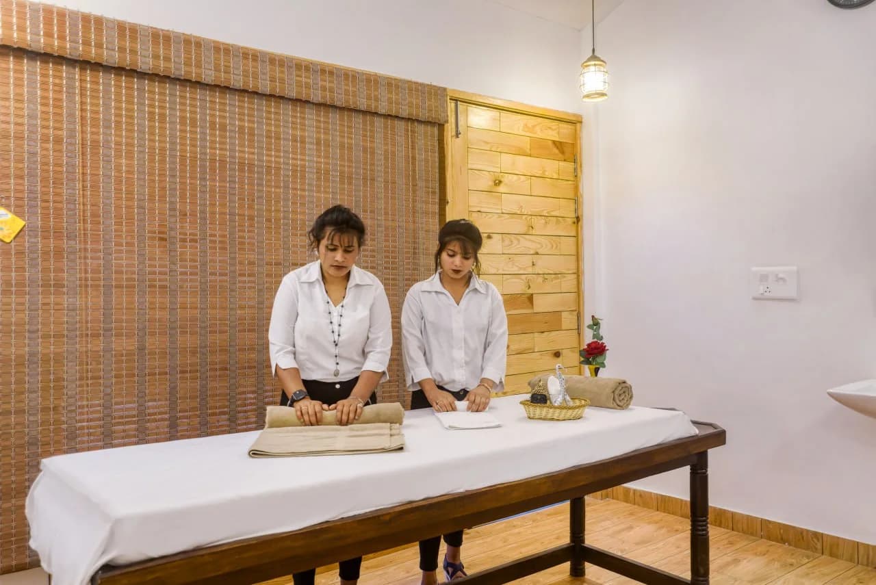 Professional Spa Therapists Preparing relaxing Massage Table