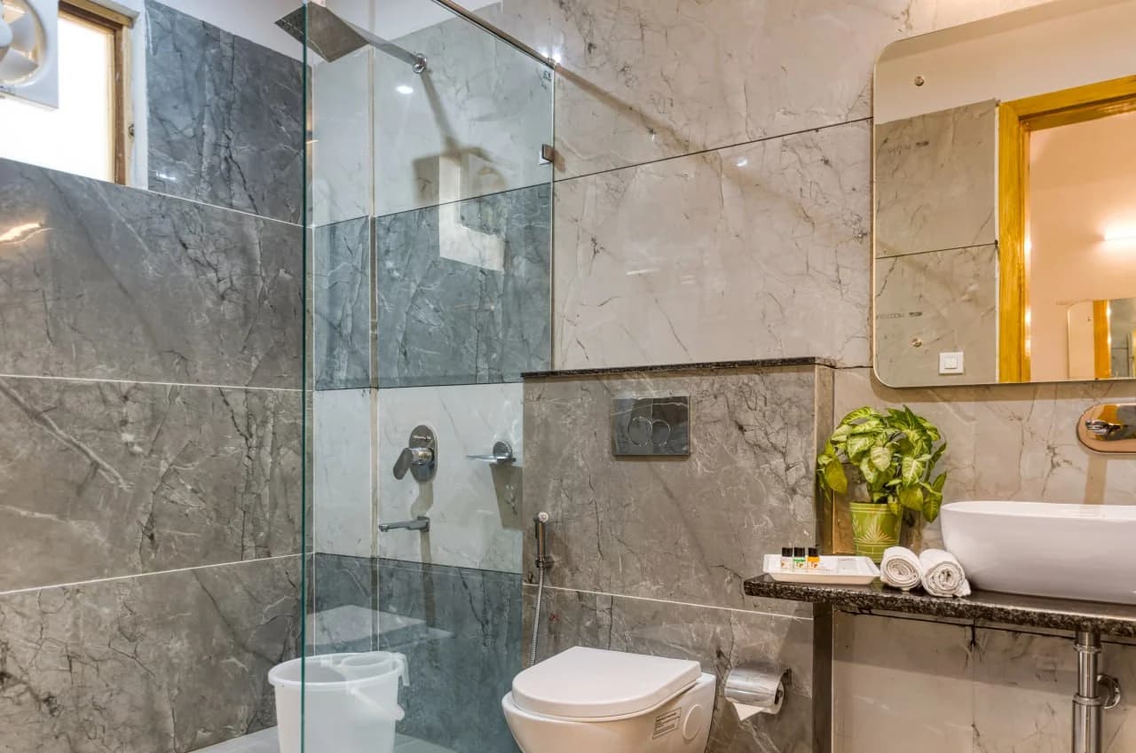 Modern Resort Bathroom with Marble Tiling and Glass Shower Enclosure